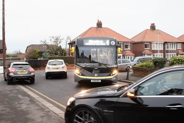 A Blackpool bus trying to navigate around parked cars
