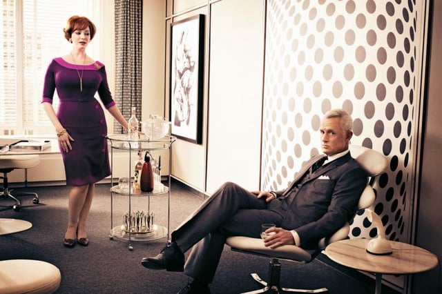 <p>Joan Holloway (Christina Hendricks) with the bar cart in Mad Men, with Roger Sterling (John Slattery)</p>