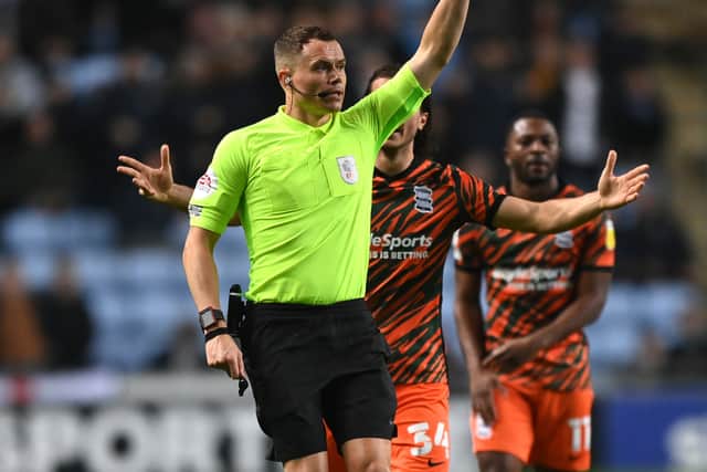 Match referee Leigh Doughty shows a red card to Ryan Woods of Birmingham City (not pictured) during the Sky Bet Championship match between Coventry City and Birmingham City at The Coventry Building Society Arena