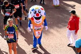 Members of the public finish during the 2021 Virgin Money London Marathon