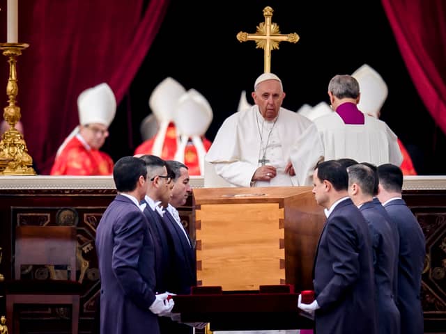 Pope Francis attends the funeral mass for Pope Emeritus Benedict XVI as pallbearers carry the coffin at the end of the funeral mass at St. Peter's square