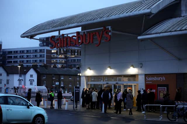 People queue outside the Sainsbury’s after reports they would be stocking the in demand drink