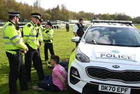 An animal rights protester is apprehended by police officers ahead of the Grand National. 