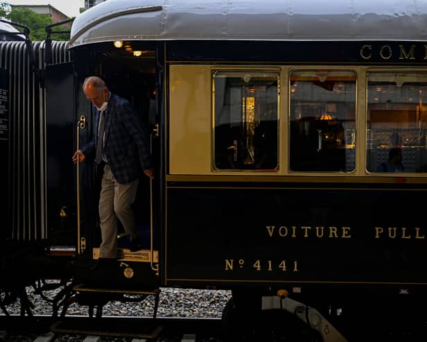 A man disembarks from the Venice Simplon-Orient-Express after arriving at Istanbul Station in Istanbul (Photo by YASIN AKGUL/AFP via Getty Images)