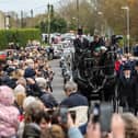 The funeral cortege for Paul O'Grady passes through the village of Aldington 