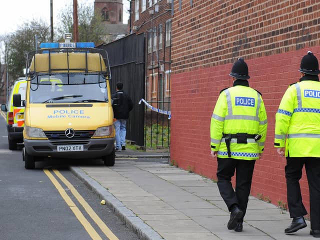 Police officers patrol the area around a house in Liverpool, north west England (PAUL ELLIS/AFP via Getty Images)