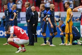 Markku Kanerva, Head Coach of Finland and Teemu Pukki of Finland wait on the pitch as Christian Eriksen (Not pictured) of Denmark receives medical treatment during the UEFA Euro 2020 Championship Group B match between Denmark and Finland on June 12, 2021 in Copenhagen, Denmark. (Photo by Stuart Franklin/Getty Images)