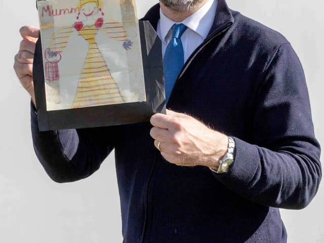 Charles Hanson, owner of Hansons Auctioneers, with a childhood drawing of Queen Elizabeth II drawn by a very young King Charles.  