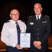 National Highways traffic officer Dereck Morrison (left) collecting his award from Chief Superintendent Mark Dexter, Head of Specialist Operations Branch at Greater Manchester Police 