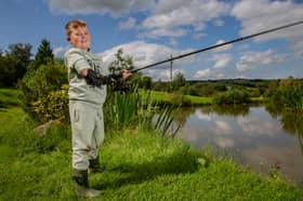 Alexander Sparkes, 7, fishing with his new Hero Arm with Dad Robin Sparkes, 31, at Cornfield Fisheries in Burnley