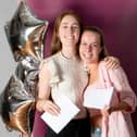 Bella Mollart and Mollie McNicholas collect their A Level results at AKS