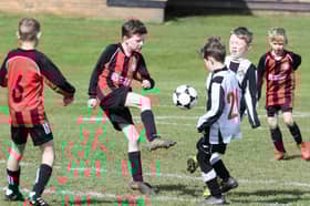Youngsters playing football at Cottam Hall Playing Fields
