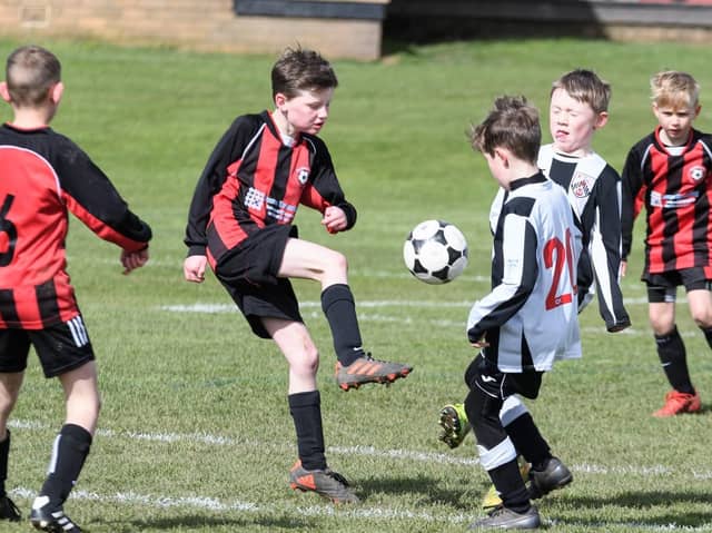Youngsters playing football at Cottam Hall Playing Fields