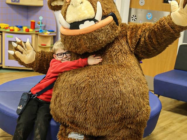The Gruffalo poses with a sick child during a visit to Blackpool Victoria Hospital