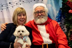 Lynne Patterson and her adorable fluffy dog pose with Santa Paws at the Stanley Park Dog Club Christmas Party (Photo credit: Elizabeth Gomm)