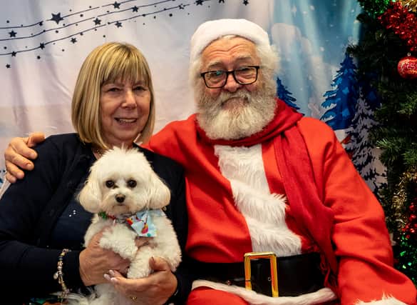 Lynne Patterson and her adorable fluffy dog pose with Santa Paws at the Stanley Park Dog Club Christmas Party (Photo credit: Elizabeth Gomm)
