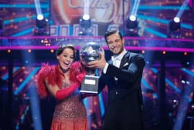 Ellie Leach and her professional dance partner Vito Coppola with the Strictly Come Dancing glitterball trophy. Credit: BBC/Guy Levy