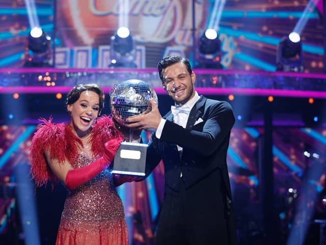 Ellie Leach and her professional dance partner Vito Coppola with the Strictly Come Dancing glitterball trophy. Credit: BBC/Guy Levy