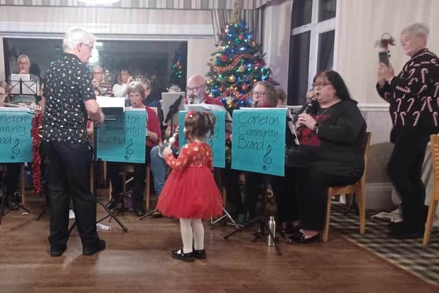 3-year-old Scarlett played the bells with the Carleton Community Band at a golf club event