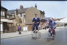 Two men riding a bone-shaker bicycle and a penny farthing on Vicarage Lane, with the Oxford Garage on Waterloo Road in the background. The photograph was probably taken in the 1950s