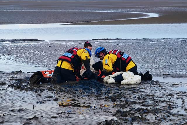 The woman was rescued from Marine Beach in Fleetwood after she found herself trapped in thick mud up to her knees - just 15 minutes before the tide swept in.