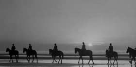 circa 1937:  Horse riders on Blackpool beach, silhouetted against the evening sky.  (Photo by Fox Photos/Getty Images)