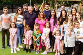 Sue and Noel Radford with eighteen of their children.