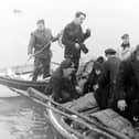 Three Blackpool youths were rescued, near the mouth of the River Ribble by Lytham Lifeboat, after spending the night in a rubber dingy. The three, who were taken to hospital, were named as Richard Walsh (16), James Varey (18) and Bobby Waddington (17). Picture shows the boys huddled together as they were brought ashore at Lytham