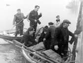 Three Blackpool youths were rescued, near the mouth of the River Ribble by Lytham Lifeboat, after spending the night in a rubber dingy. The three, who were taken to hospital, were named as Richard Walsh (16), James Varey (18) and Bobby Waddington (17). Picture shows the boys huddled together as they were brought ashore at Lytham