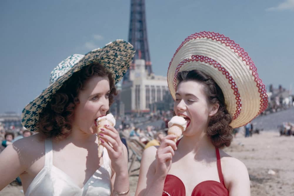 Two girls enjoy ice creams on the sands at Blackpool, July 1954. Blackpool Tower can be seen in the background. Original publication: Picture Post - 7227 - Blackpool - pub. 31st July 1954 (Photo by John Chillingworth/Picture Post/Hulton Archive/Getty Images)