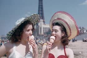 Two girls enjoy ice creams on the sands at Blackpool, July 1954. Blackpool Tower can be seen in the background. Original publication: Picture Post - 7227 - Blackpool - pub. 31st July 1954 (Photo by John Chillingworth/Picture Post/Hulton Archive/Getty Images)