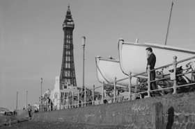 A man looks out over the beach in front of Blackpool Tower next to two large boats supported on carriages, 1950 (Photo by The Montifraulo Collection/Getty Images)