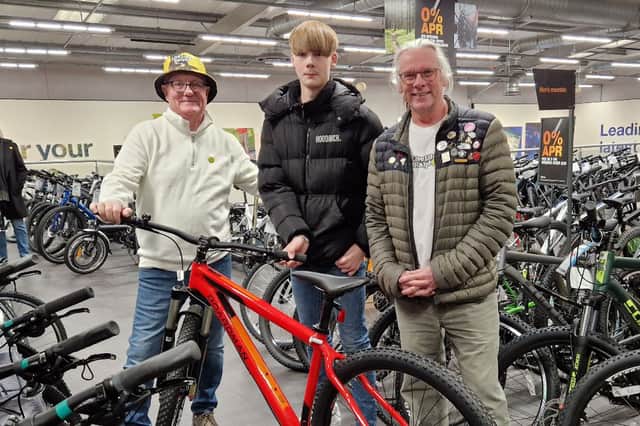 David Nuttall and Neil Roberts take Callum to pick out a new bike after his was stolen.