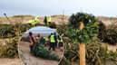 Volunteers plant old Christmas trees in the sand dunes at St Annes