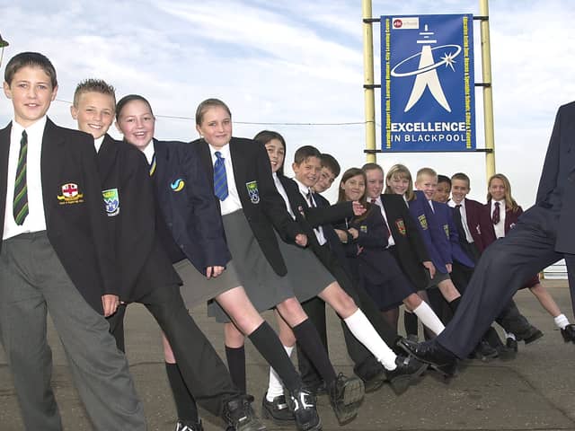 Best foot forward.  Education Director from Blackpool Dr David Sanders and School Children from the Blackpool area in front of the Excellence sign on the promonade.