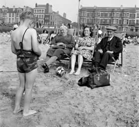 A child photographs his mother and grandparents on the beach, c1946-c1955. The Promenade provides a backdrop. (Photo by English Heritage/Heritage Images/Getty Images)