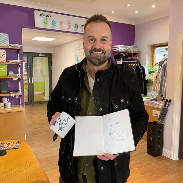 Alfie signed a Derian mug and notepad while visiting the hospice.