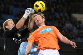 Manchester City's English goalkeeper Joe Hart (L) punches clear from Blackpool's Australian defender David Carney (R) during the English Premier League football match between Manchester City and Blackpool at The City of Manchester Stadium, Manchester, north-west England on January 1, 2011.