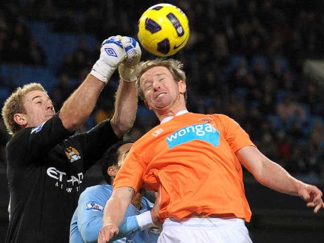 Manchester City's English goalkeeper Joe Hart (L) punches clear from Blackpool's Australian defender David Carney (R) during the English Premier League football match between Manchester City and Blackpool at The City of Manchester Stadium, Manchester, north-west England on January 1, 2011.