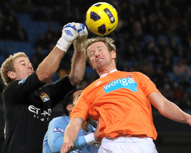 Manchester City's English goalkeeper Joe Hart (L) punches clear from Blackpool's Australian defender David Carney (R) during the English Premier League football match between Manchester City and Blackpool at The City of Manchester Stadium, Manchester, north-west England on January 1, 2011.