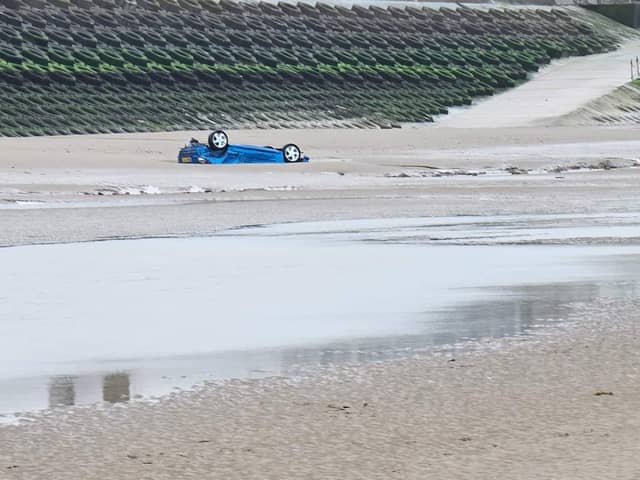 Parts of a Corsa and 206 convertible were spotted, partially buried in the sand opposite the new Hilton Hotel on Blackpool Promenade.