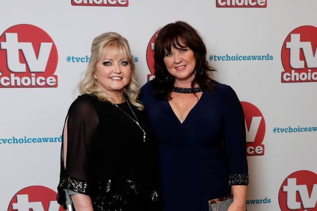 Coleen Nolan (R) has shared an emotional health update regarding her sister, Linda (L) (Photo by John Phillips/Getty Images) 