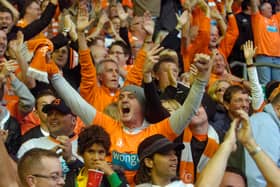 The travelling Blackpool fans celebrate their side's Premier League victory over Liverpool at Anfield in October 2010