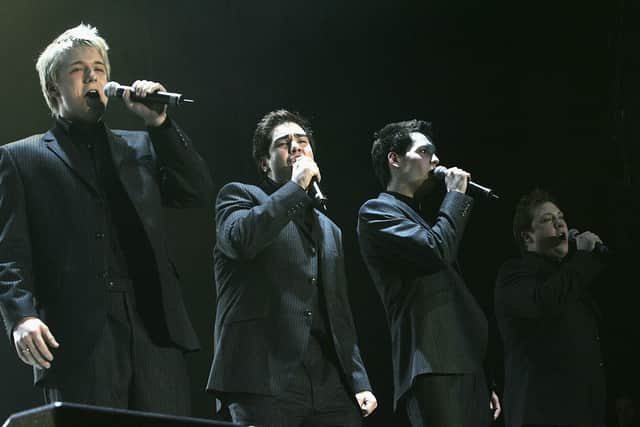 Jonathan (far left) and Mike (third), alongside former G4 members Ben Thapa (left of Mike) and Matt Stiff (far right), performing at the "The X Factor Live" UK tour in 2005. Credit: Getty
