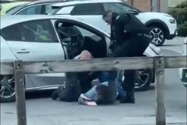 In the video, the officer was filmed dragging the driver out of a Ford Focus and wrestling him to the floor before stamping on his back as another officer applied handcuffs. He is then seen swinging a kick at the man's head and repeatedly slapping the suspect who was detained on the ground.