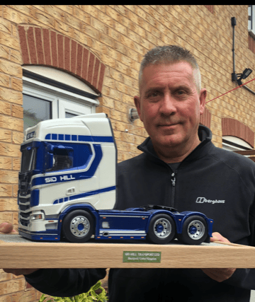 Carl Eggenton with his amazing model of a Sid Hill truck, made almost entirely from cardboard and paper.