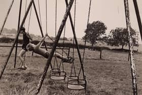 Youngsters on swings in a park, probably 1980s. But where was this?
