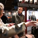 Princess Anne being talked through how some of the machines work at Helmshore Mills.