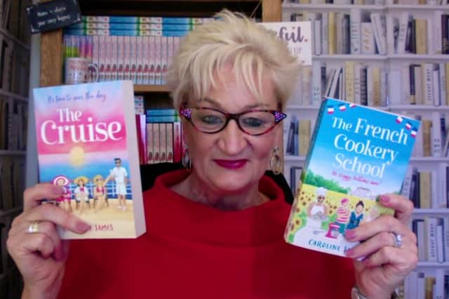 Caroline, pictured with some of her books, says she was told to sit at the back of the class so she didn't hold the others back. 