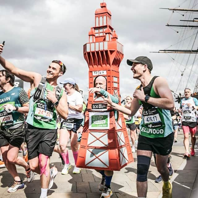 Tony posing for a selfie with other marathon runners.